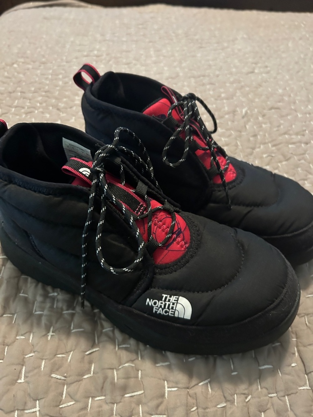 The North Face women’s Black and Pink Quilted Insulated Boots